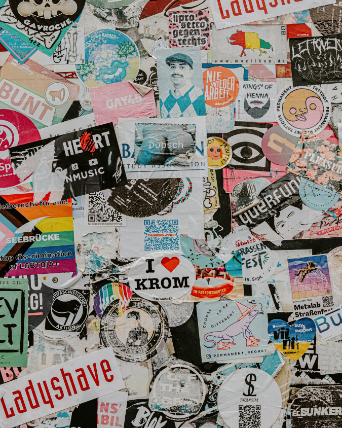 Ganz viele Sticker durcheinander auf einer Wand. 